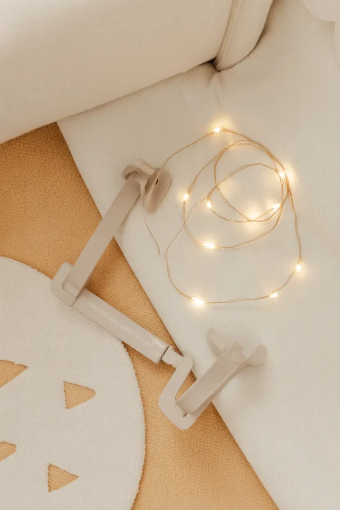 Safety essentials for a toddler reading corner including anti-tip strap and battery fairy lights