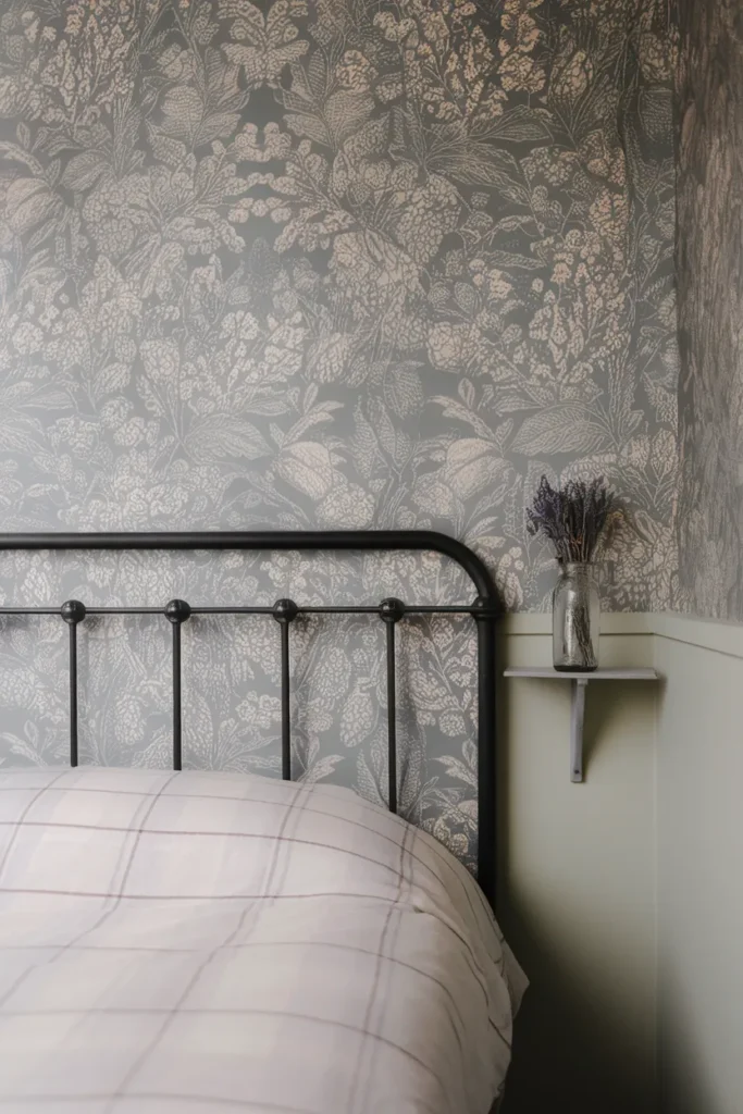 Floral peel and stick accent wall behind an iron bed, cottagecore bedroom ideas for small rooms
