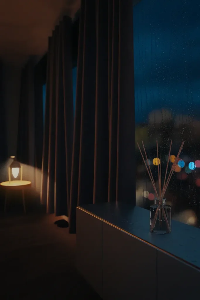 Dark apartment at night lit by a single warm lamp, with rain on the window and heavy curtains.