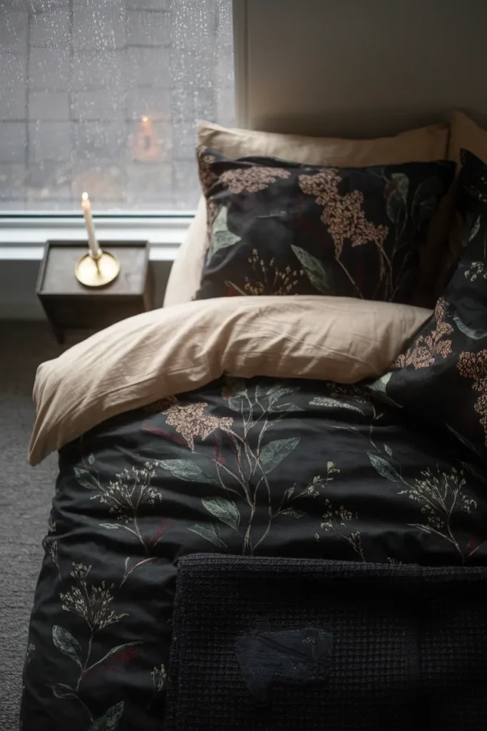 Dark cottagecore bedding with moss and oxblood botanical print on a rainy overcast afternoon