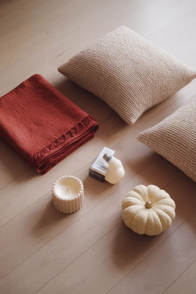 Six items laid out for the 3-2-1 fall rule throw, two pillow covers, bulb, candle, pumpkin.