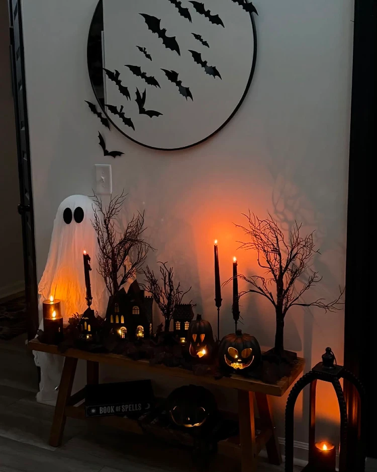 Spooky Halloween console table display with a lit miniature haunted village