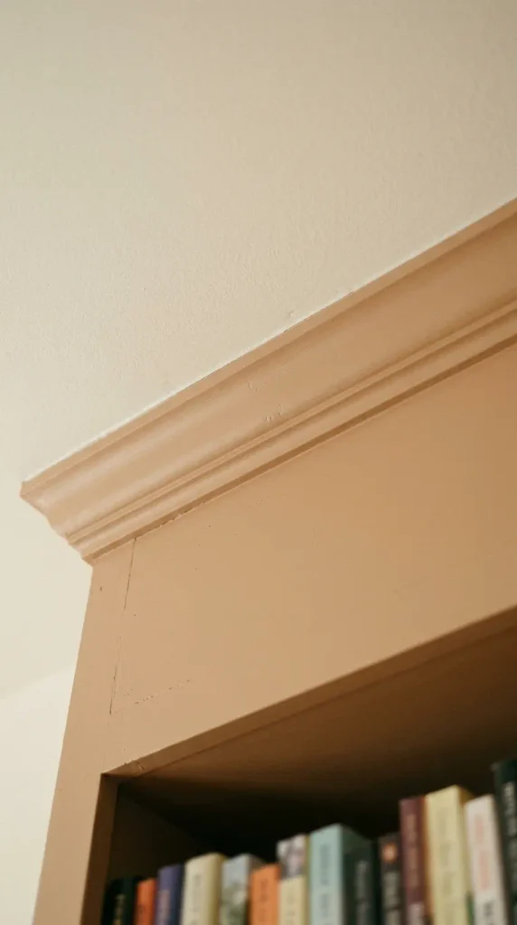 Built-in bookshelves finished with crown molding tight to the ceiling
